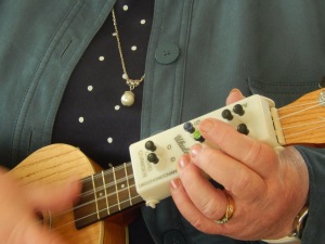 Participant at ukulele group using a chord changer